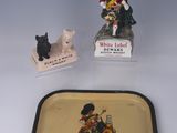 a small tray with a bottle of white label and a small figurine of a man