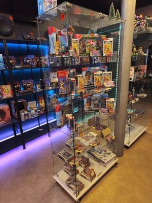a glass display case with a lot of toys inside of it