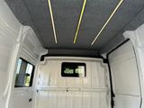 the inside of a van with a door open and a window open
