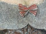 a painting of a woman wearing a dress with a red bow