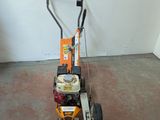 a small lawn mower that is sitting on the floor