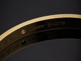 a close up of a gold watch with a black background