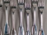 a lot of forks and spoons that are on a table