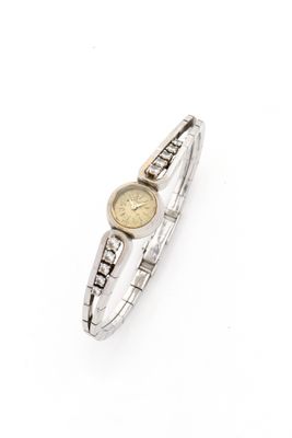 a close up of a wrist watch on a white surface