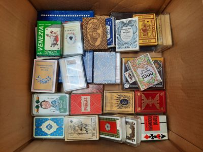 a cardboard box filled with many different types of playing cards