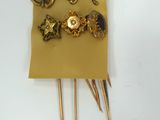 a gold brooch that has a bunch of gold brooches on it