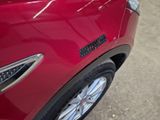 a close up of a red car with a sticker on it