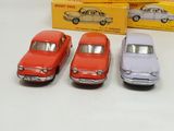 three toy cars sitting next to each other on a table