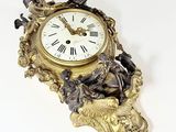 a clock that is sitting on the wall with a bird on it