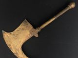 an old axe with a wooden handle on a black surface
