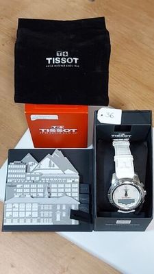 a box with a watch inside of it on a table