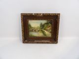 une peinture à l'huile représentant un pont au-dessus d'une rivière, dans un cadre en bois