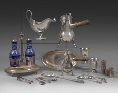 a silver plate and silverware on display on a table