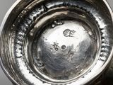 a close up of a silver vase on a table