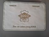 a badge on the back of a suitcase that says soco