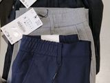 a lot of men ' s clothing on display in a store