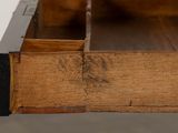 a close up of a wooden table with a drawer on it