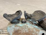 two pairs of shoes that are on top of a piece of metal