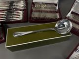 a lot of silverware in a box on a table