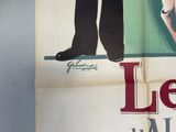 a poster of a man in a tuxedo standing next to a woman