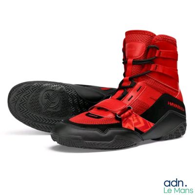 pair of red and black shoes with black soles on a white background