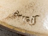 a close up of a vase with writing on it