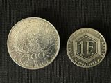 two coins that are on a black surface