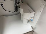 a sink under a cabinet with a water dispenser in it