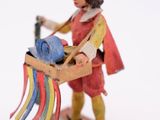 a figurine of a man with a plow in his hand