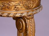a gold table with a marble top on it
