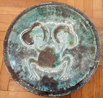 a metal plate with a picture of two people on it