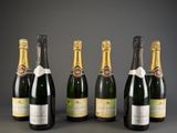 six bottles of champagne are lined up in a row