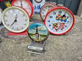 many clocks that are sitting on the ground