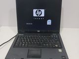 hp laptop computer with a black keyboard and mouse on a white table