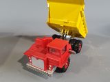 a toy truck with a yellow dumper on the back of it