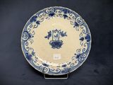 an old blue and white plate with a bird on it