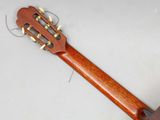 a close up of an acoustic guitar on a white surface
