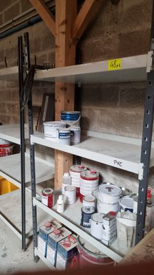 many shelves with paint and other items on them