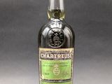 a bottle of chartreuse irish whiskey on a grey background