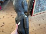 a person holding a statue in their hand in a room