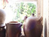 three vases sitting on a window sill next to a window