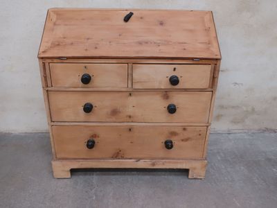 a wooden dresser with three drawers and a black knob