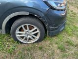 a car that has been damaged and is sitting in the grass