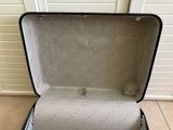 a black suitcase that is open on the floor