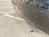 a close up of a car ' s bumper with smoke coming out of it