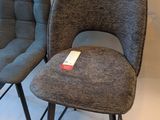 two chairs sitting next to each other on a white floor