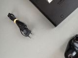 a laptop and a pair of black shoes on a table
