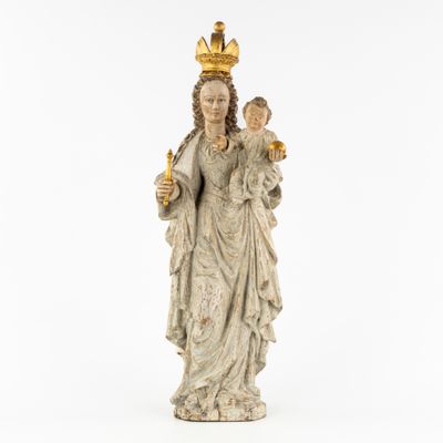 a statue of a woman holding a child wearing a crown