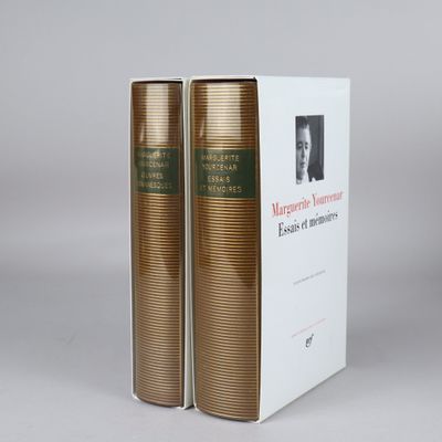 two books sitting on top of each other in front of a white box