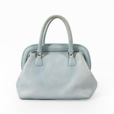 blue leather handbag on a white background